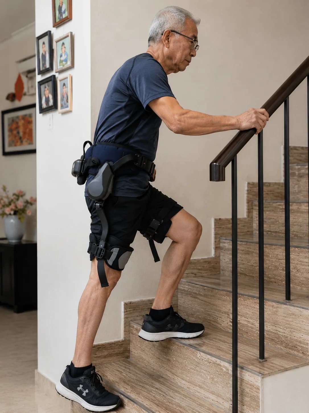 Elderly man climbing stairs at home with the walking exoskeleton for support